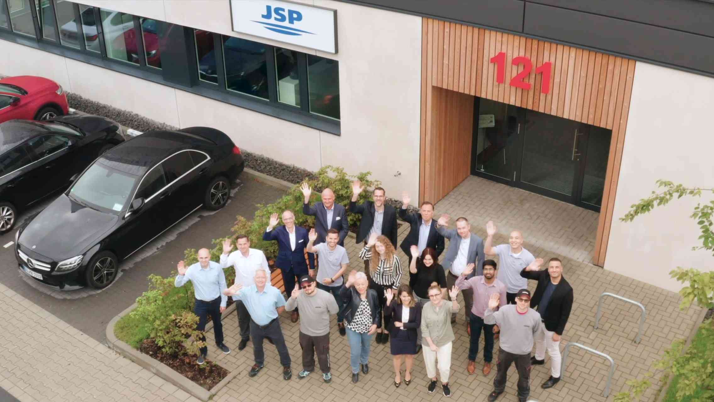 JSP team stand outside the Innovation Centre waving 